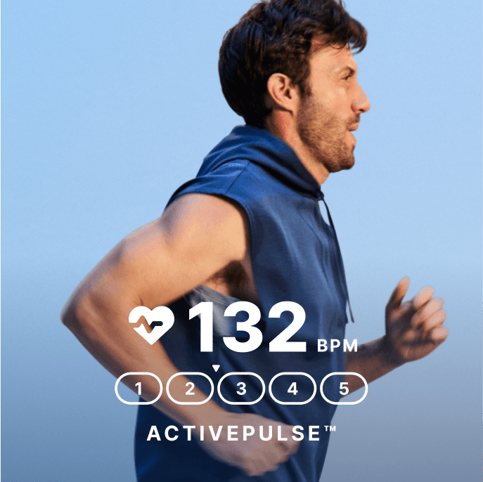 A man in a blue sleeveless hoodie running, pumping his arms for momentum.