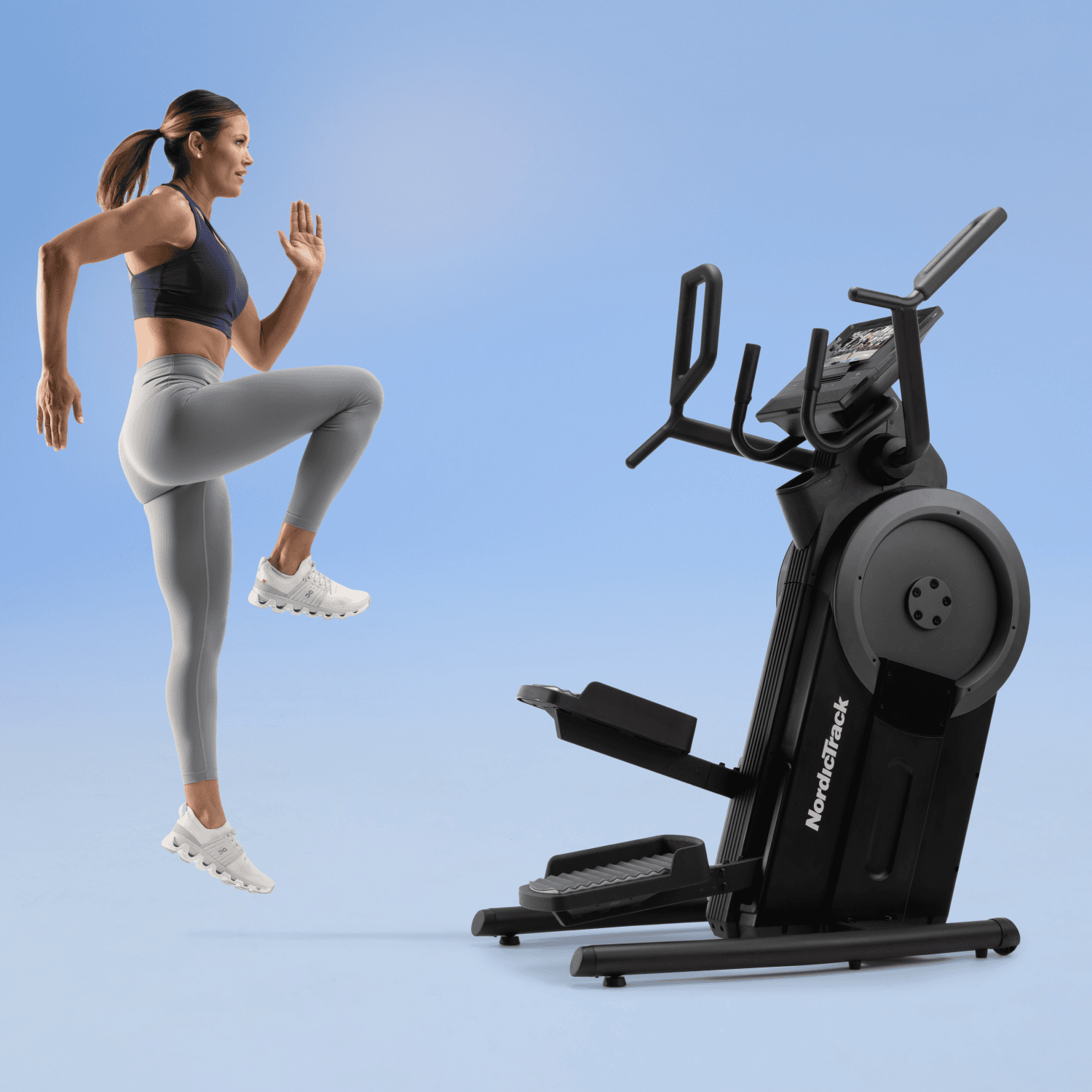 woman exercising next to the NordicTrack step climber