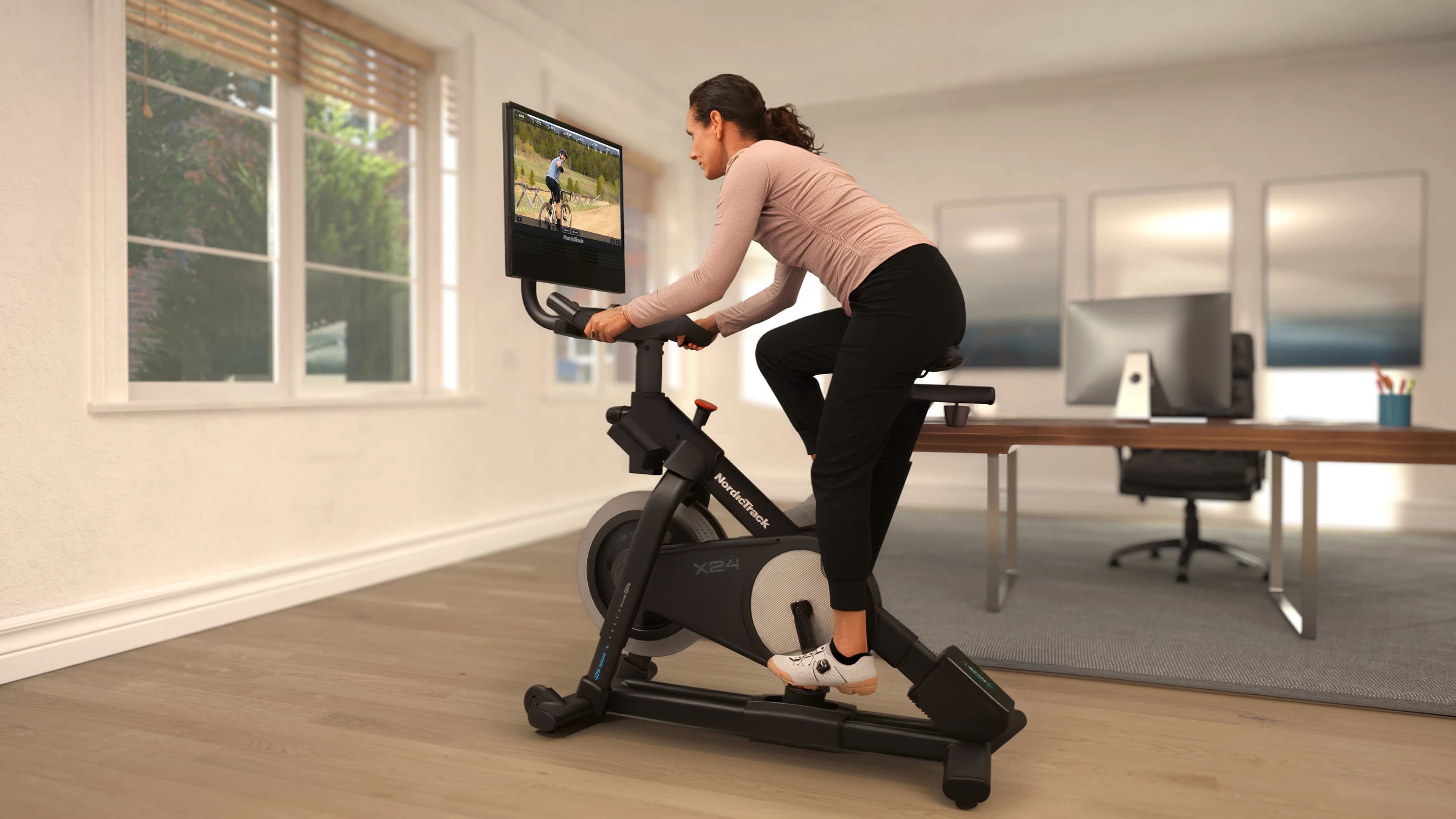 The NordicTrack X24 Exercise Bike features a pivoting 24-inch touchscreen and iFIT terrain-based workouts that automatically adjust incline and resistance to match your ride.